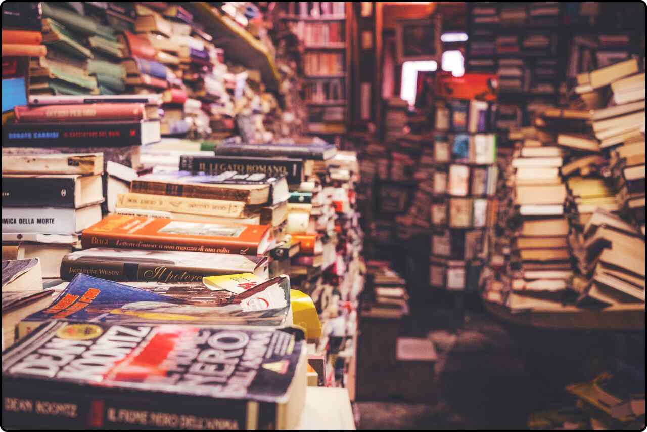 A stack of books arranged neatly on a flat surface.